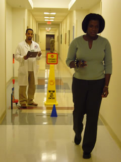 A respiratory therapist watches as a patients does the six minute walk test.