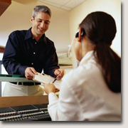 A patient handing in a completed form.