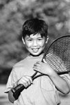 Photo of a boy holding a tennis racket.
