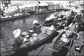 Image of South East Asians with boats on river