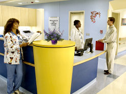 Nurses at the nurse station discussing a patient's progress