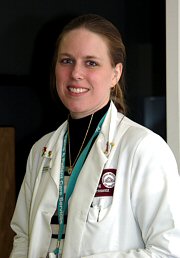 A senior clinical research nurse, smiling.