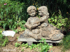 Sculpture of two children reading a book
