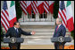 President George W. Bush listens as Italian Prime Minister Silvio Berlusconi addresses his remarks at a joint press availability Monday, Oct. 13, 2008, in the White House Rose Garden. Prime Minister Berlusconi said that Italy and America share a special friendship which has its roots in common values, in sharing a world which is inspired by love for democracy and freedom. White House photo by Chris Greenberg