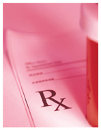 Photograph of a pill bottle sitting on top of a prescription pad.