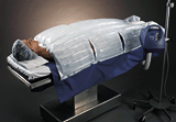 photo of patient lying under a disposable blanket