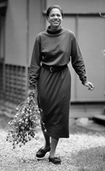 Photo of a woman walking carrying dried flowers