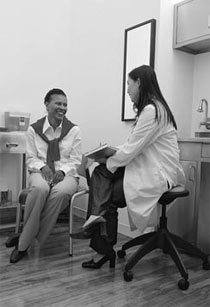 Photo of a doctor and a patient talking.