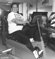 Photo of a large woman on an exercise bike.