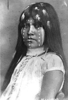 An old photograph of a young, traditionally dressed Pima Indian girl.