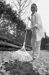 Photo of woman raking leaves.