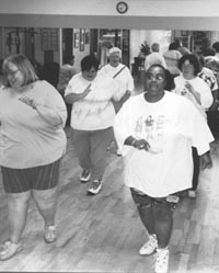 Photo of several large women walking in place.