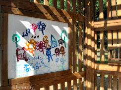 Children's artwork displayed in the garden