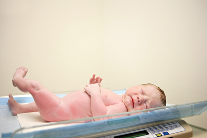newborn baby being weighed