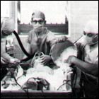A photograph of  open-heart surgery 
            performed at the NIH Clinical Center using hypothermia. The patient 
            was placed in a bed of ice to lower the total body temperature so 
            that body tissues used very little oxygen. This permitted interuption 
            of the blood flow for a brief period so that some procedures could 
            be performed. This technique preceded the advent of the heart-lung 
            machine, which today takes over the job of pumping blood during heart 
            surgery.