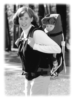 picture of mother carrying an infant on her back in a carrier