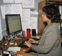 Kelli uses her computer to communicate with colleagues, coordinate meetings, and conduct research for reports.