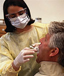 Image of a dentist examing patient's mouth
