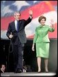 President George W. Bush and Laura Bush wave to young supporters during the pre-inaugural event 'America's Future Rocks Today- A Call to Service' youth event at the DC Armory in Washington, D.C., Tuesday, Jan. 18, 2005. The event highlighted the importance of volunteerism and community service in America's neighborhoods. White House photo by Susan Sterner