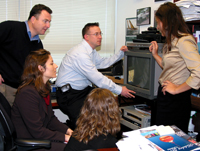 Geoff and his colleagues gather to review an NHGRI promotional video.