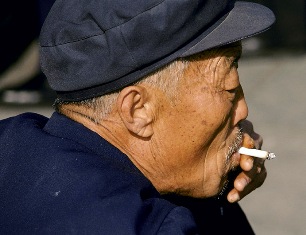 A Chinese man smoking a cigarette.