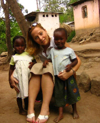 Gretchen Birbeck posing with two little African girls