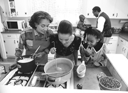 Photo of a family cooking together in the kitchen.