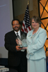 a photo of NIBIB Director Dr. Roderic Pettigrew presenting an award to M. Joan Dawson