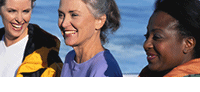 Photo of three women walking and smiling