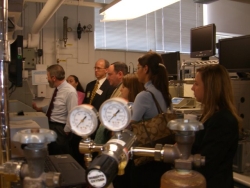 Photo of Terry Phillips giving tour participants a firsthand look at new technologies used for the analysis and identification of biological molecules