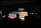 President George W. Bush is silhouetted against the renovated Star-Spangled Banner American flag exhibit Wednesday, Nov. 19, 2008, during his visit with Mrs. Laura Bush to the National Museum of American History in Washington, D.C. The flag, which flew above Fort McHenry in Baltimore during the British attack in 1814, inspired Francis Scott Key to write the lyrics that became our national anthem. White House photo by Eric Draper