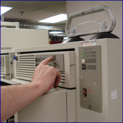 A photo of a man's arm reaching out to flip a switch to the on position.