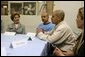 Laura Bush talks with, from left, Gabriel Flores, Archie Dominguez and Shirley Torres during a discussion at Homeboy Industries in Los Angeles April 27, 2005. Homeboys Industries is an job-training program that educates, trains and finds jobs for at-risk and gang-involved youth. White House photo by Krisanne Johnson