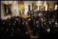 The audience bows its head as Major General David Hicks, standing at the podium, gives the invocation Monday, April 4, 2005, during the posthumous Medal of Honor ceremony for Sgt. 1st Class Paul Smith at the White House.White House photo by Paul Morse