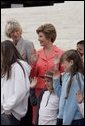 Laura Bush and Interior Secretary Gale Norton joins Guilford Elementary School students in taking the Junior Ranger pledge from National Park Service Director Fran Mainella during during an event at the Thomas Jefferson Memorial in Washington, D.C., April 21, 2005. White House photo by Paul Morse