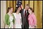 President George W. Bush congratulates ninth graders from Hawken School of Geauga County, Ohio, on receiving the President’s Environmental Youth Award in the East Room of the White House April 21, 2005. Members include, from left to right, Karoline Evin McMullen, 14, Angela Primbas, 14, and Amanda Weatherhead, 15. White House photo by Paul Morse