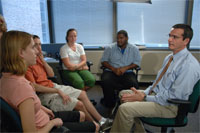 group of five 
people sitting in 
therapy session