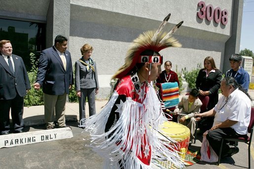 Laura Bush listens to a drumming performance by Native American children before touring the Native American Community Health Center Phoenix, Ariz., April 26, 2005. The center provides health care and other outreach services such as traditional ceremony training, dental care, women's wellness programming and case management services to Phoenix-area Native Americans. White House photo by Krisanne Johnson