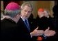 President George W. Bush gestures as he talks with Justin Cardinal Rigali, Archbishop of Philadelphia, during a reception Thursday, April 7, 2005, in Rome. The gathering at the home of the U.S. Ambassador to Italy was attended by American Cardinals, Archbishops and Bishops of the Catholic Church, on hand for Friday's funeral of Pope John Paul II. White House photo by Eric Draper