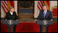 President George W. Bush and German Chancellor Angela Merkel react to a reporter’s question during a joint news conference at the White House, Thursday, Jan. 4, 2006, where they answered questions on Iraq, the Middle East and U.S.-European economic issues. White House photo by Paul Morse