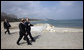 With the Black Sea behind them, President George W. Bush and President Taian Basescu walk along a pier Wednesday, April 2, 2008, during a tour of the Romanian leader’s presidential retreat in Neptun, Romania. White House photo by Eric Draper