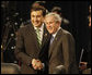 President George W. Bush and President Mikheil Saakashvili of Georgia, shake hands as they smile at cameras before the start of the afternoon session of the 2008 NATO Summit in Bucharest. White House photo by Eric Draper