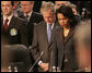 President George W. Bush bows his head as he stands with Secretary of State Condoleezza Rice Thursday, April 3, 2008, at the start of the North Atlantic Council Summit in Bucharest. White House photo by Chris Greenberg