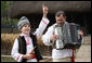 A young boy sings and dances as he’s accompanied by an accordionist during a performance for the official NATO Spouses’ Program Thursday, April 3, 2008, at the Dimitrie Gusti Village Museum in Bucharest. White House photo by Shealah Craighead