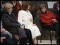 Mrs. Laura Bush leans in to listen to Alexandra Coman, fiance of Romania’s Foreign Minister Adrian Cioroianu, as they join other guests, including Mrs. Maria Basescu, in white, spouse of Romania’s President Taian Basescu, and Mrs. Jeannie de Hoop Scheffer, spouse of NATO Secretary General Jaap de Hoop Scheffer, at the Dimitrie Gusti Village museum in Bucharest. White House photo by Shealah Craighead