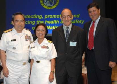 From left are acting Surgeon General Kenneth Moritsugu, newly promoted Capt. Vien Vanderhoof, William Current-Garcia and NIH director Dr. Elias Zerhouni.