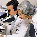 two researchers using microscopes