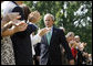 President George W. Bush is applauded following his remarks highlighting the achievements of volunteerism and work of the USA Freedom Corps Monday, Sept. 8, 2008, on the South Lawn of the White House. White House photo by Eric Draper