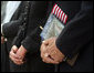 Vice President Dick Cheney is seen holding a flag and a commemorative program during the dedication ceremony of the 9/11 Pentagon Memorial Thursday, Sept. 11, 2008, at the Pentagon in Arlington, Va. White House photo by David Bohrer