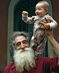 Elderly man holding a child